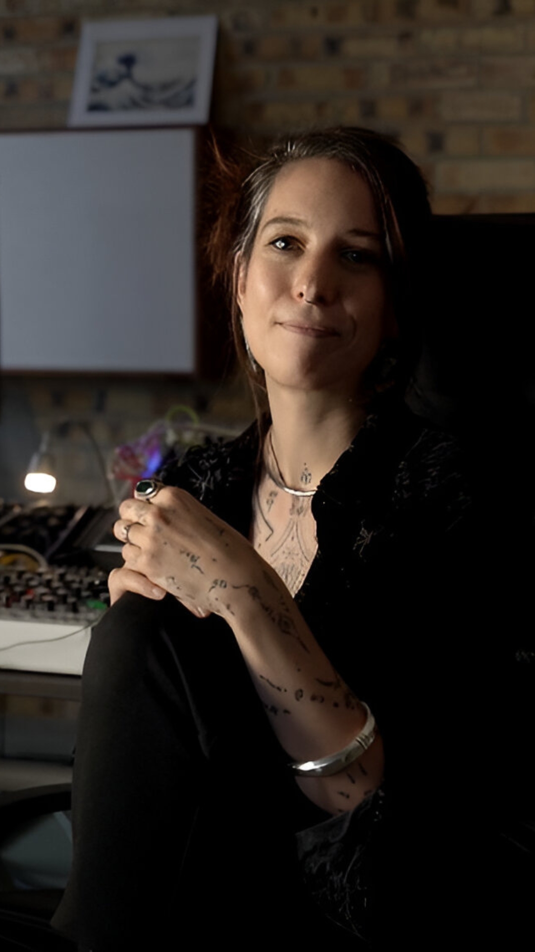 Ninon Devis Salvy seated in the studio beside a modular synthesiser